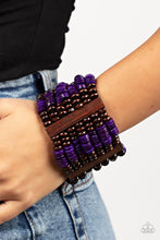 Load image into Gallery viewer, Held together by rectangular wooden frames, rows of brown wooden and distressed purple discs are threaded along stretchy bands around the wrist for a seasonal pop of color around the wrist.
