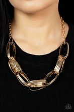 Load image into Gallery viewer, Brushed in an antiqued shimmer, pairs of oversized oval gold links dramatically connect into a gritty chain below the collar for a bold industrial look. Features an adjustable clasp closure. 
