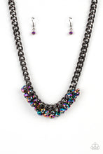 Load image into Gallery viewer, Flecked in oil spill iridescence, a faceted collection of metallic beads cluster along the center of a chunky gunmetal curb chain, creating a stellar fringe below the collar. Features an adjustable clasp closure.  Sold as one individual necklace. Includes one pair of matching earrings.
