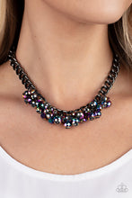 Load image into Gallery viewer, Flecked in oil spill iridescence, a faceted collection of metallic beads cluster along the center of a chunky gunmetal curb chain, creating a stellar fringe below the collar. Features an adjustable clasp closure.  Sold as one individual necklace. Includes one pair of matching earrings.
