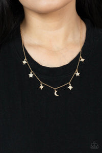 Dotted with dainty white rhinestones, a stellar collection of gold moon and star charms swing from a dainty gold chain below the collar, creating a cosmic fringe. Features an adjustable clasp closure. 