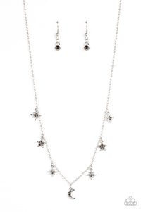 Dotted with dainty hematite rhinestones, a stellar collection of silver moon and star charms swing from a dainty silver chain below the collar, creating a cosmic fringe. Features an adjustable clasp closure.