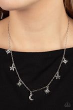 Load image into Gallery viewer, Dotted with dainty hematite rhinestones, a stellar collection of silver moon and star charms swing from a dainty silver chain below the collar, creating a cosmic fringe. Features an adjustable clasp closure.
