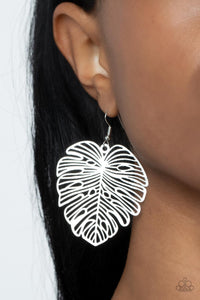 A stenciled silver palm-like leaf delicately swings from the ear, creating a refined seasonal display. Earring attaches to a standard fishhook fitting.