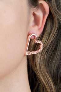 One side of a shiny copper heart frame is subtlety twisted with twinkly texture, creating a romantic display. Earring attaches to a standard post fitting.