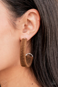 Brown suede cording crisscrosses around a layered silver frame that widens as it curves into a simple hoop, creating a textured handcrafted design. Hoop measures approximately 2" in diameter. Earring attaches to a standard post fitting.  Sold as one pair of hoop earrings.