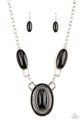 Featuring abstract square fittings, a pair of oblong black beaded frames link to a dramatically oversized silver pendant below the collar. Bordered in rope-like texture, the hammered pendant features a matching black bead for a powerful pop of color. Features an adjustable clasp closure.