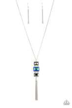 Load image into Gallery viewer, A sparkly collection of mismatched smoky, blue, and hematite rectangular gems stack at the bottom of a lengthened silver chain, creating a glamorous pendant. A dainty silver chain tassel swings from the bottom, adding glamorous movement to the modern display. Features an adjustable clasp closure.
