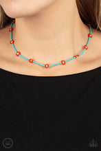 Load image into Gallery viewer, A dainty strand of turquoise seed beads is dotted with red and yellow beaded floral frames, creating a flirtatious floral look around the neck. Features an adjustable clasp closure. 
