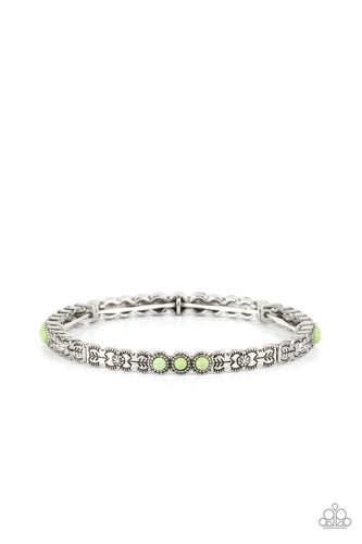 Stamped and studded in floral and arrow patterns, dainty silver frames adorned in trios of smooth green stones are threaded along stretchy bands around the wrist for a colorfully seasonal look