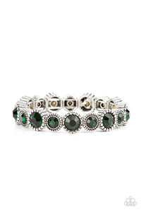 Sparkling green gems are encased in studded silver frames. Varying in size, smaller gems alternate with larger gems along stretchy bands around the wrist for a dramatic look. 