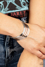 Load image into Gallery viewer, Layers of flat silver bars delicately curve in a wavy fashion across the wrist, coalescing into an airy cuff. 
