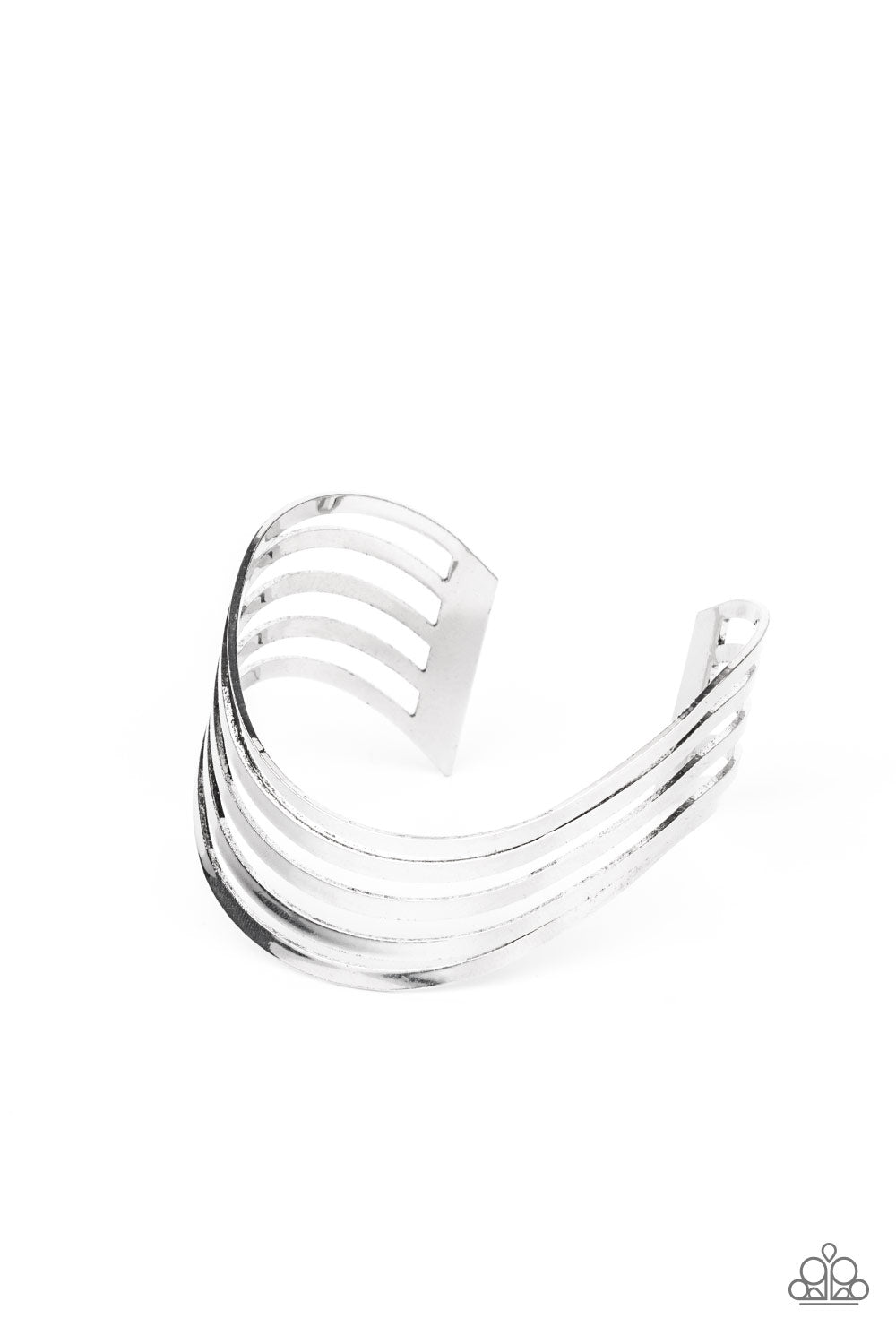 Layers of flat silver bars delicately curve in a wavy fashion across the wrist, coalescing into an airy cuff. 