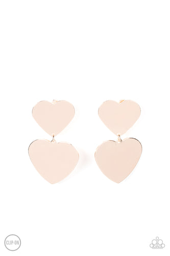 Featuring a shimmery scratched finish, an oversized rose gold heart charm swings from the bottom of a smaller rose gold heart charm, resulting in a flirtatious lure. Earring attaches to a standard clip-on fitting.