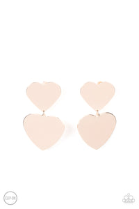 Featuring a shimmery scratched finish, an oversized rose gold heart charm swings from the bottom of a smaller rose gold heart charm, resulting in a flirtatious lure. Earring attaches to a standard clip-on fitting.