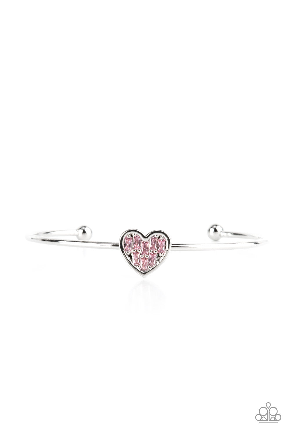 Brimming with dainty emerald-cut pink rhinestones, a simple silver heart frame sits atop a classic silver bar curved into a simple cuff bracelet for a whimsical display across the wrist. 