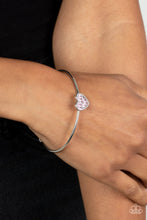 Load image into Gallery viewer, Brimming with dainty emerald-cut pink rhinestones, a simple silver heart frame sits atop a classic silver bar curved into a simple cuff bracelet for a whimsical display across the wrist. 
