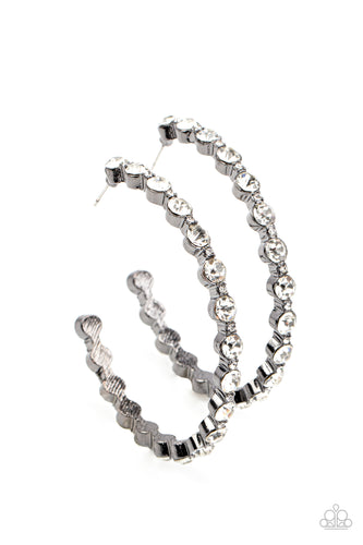 Encased in sleek gunmetal fittings, a glamorous collection of glittery white rhinestones delicately coalesce into an oversized hoop for a sparkly statement. Earring attaches to a standard post fitting. Hoop measures approximately 2 1/2