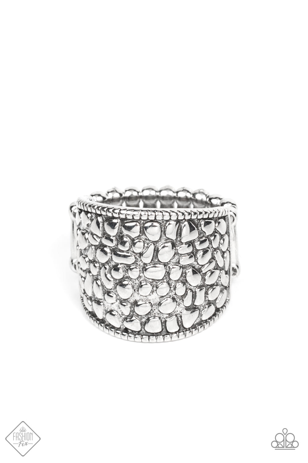 Brimming from edge to edge with a studded texture reminiscent of cobblestone, a wide silver band is bordered in dainty studs resulting in a free-spirited fashion atop the finger. Features a stretchy band for a flexible fit.  Sold as one individual ring.  Fashion Fix New Kit