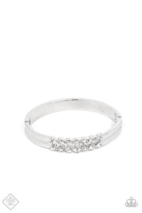 Stacked layers of brilliant white rhinestones give way to double layers of sleek silver frames that feature a subtle wave, creating a dramatically modern design around the wrist. Features a hinged closure.  Sold as one individual bracelet.