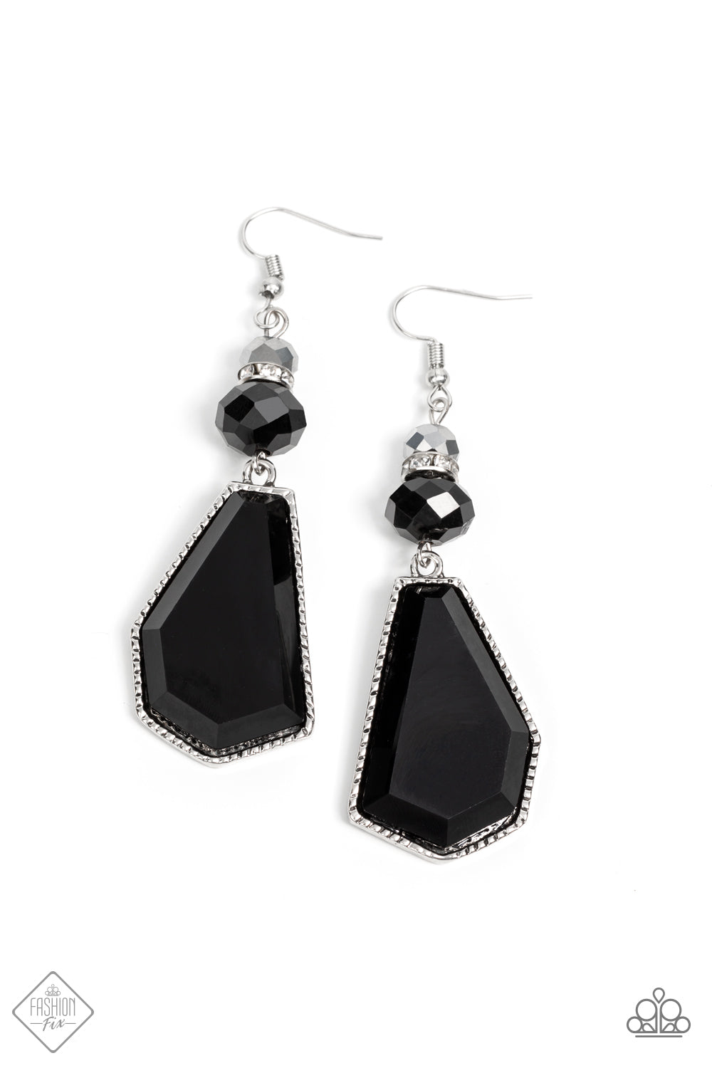 A shiny metallic bead, a white rhinestone encrusted accent, and a black defaced bead stack together above an oversized defaced bead. The sleek black asymmetrical pendant is encased in a studded silver frame, creating an edgy lure. Earring attaches to a standard fishhook fitting.  Sold as one pair of earrings.  New Kit Fashion Fix