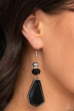 Load image into Gallery viewer, A shiny metallic bead, a white rhinestone encrusted accent, and a black defaced bead stack together above an oversized defaced bead. The sleek black asymmetrical pendant is encased in a studded silver frame, creating an edgy lure. Earring attaches to a standard fishhook fitting.  Sold as one pair of earrings.  New Kit Fashion Fix
