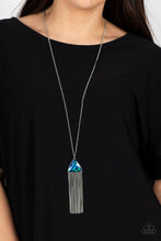 Load image into Gallery viewer, Featuring an iridescent UV shimmer, an oversized multicolored triangular gem swings from the bottom of a lengthened silver chain. A curtain of silver chains streams out from the bottom of the sparkly pendant, adding playful movement to the glamorous statement piece. Features an adjustable clasp closure. 
