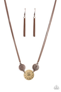 Individually stamped in "Let," "Your Light," Shine," a pair of rustic copper discs and a single brass disc, combining into an inspirational phrase below the collar. Features an adjustable clasp closure.
