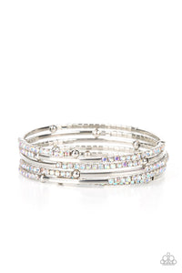 A dainty infinity style bracelet is infused with glittery rows of iridescent rhinestones and curving silver frames, creating simmering layers around the wrist.  Sold as one individual bracelet.