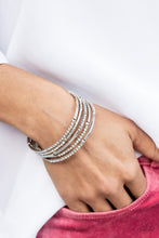 Load image into Gallery viewer, A dainty infinity style bracelet is infused with glittery rows of iridescent rhinestones and curving silver frames, creating simmering layers around the wrist.  Sold as one individual bracelet.
