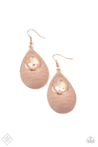 A shiny rose gold teardrop is hammered in texture, creating a radiant display as the light bounces off each beveled surface. A faceted iridescent teardrop gem with Pale Rosette undertones is pressed into the top of the rose gold frame in an enchanting finish. Earring attaches to a standard fishhook fitting.  Sold as one pair of earrings.