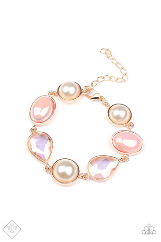 A collection of classic white pearls, Pale Rosette pearls glazed in a reflective finish, and iridescent teardrops wrap around the wrist in an ethereal display. Rose gold frames encase each bead, adding a romantic vibe to the vintage inspired design. Features an adjustable clasp closure.