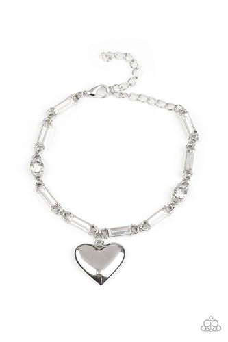 Encased in sleek silver fittings, round and emerald cut rhinestones delicately link into a sparkly chain around the wrist. A shiny silver heart charm swings from the glittery compilation, adding a flirtatious shimmer. Features an adjustable clasp closure.