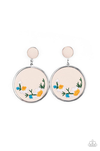 A small leather disc, encased in a simple silver frame, anchors a larger leather circle that is adorned with fanciful embroidered flowers creating a whimsical lure. Earring attaches to a standard post fitting. 
