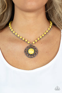 A dainty silver chain is paired with an Illuminating stone beaded chain below the collar. An oversized Illuminating stone adorns the center of an antiqued silver frame radiating with silver studded and wire-like detail, creating an authentic artisan inspired pendant at the bottom of the earthy chains. Features an adjustable clasp closure.