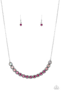 Encased in studded silver fittings, a glittery ombré of pink rhinestones delicately bows below the collar, creating an enchanting pop of color. Features an adjustable clasp closure.