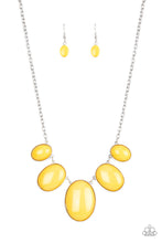 Load image into Gallery viewer, Encased in studded silver fittings, oversized oval mustard yellow frames gradually increase in size as they link below the collar for a dramatic pop of color. Features an adjustable clasp closure.
