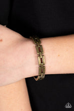 Load image into Gallery viewer, An antiqued row of rectangular brass links boldly interlock across the top of the wrist, coalescing into an edgy bangle-like bracelet. Features a hinged closure.
