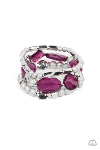 Infused with vivacious pops of plum crystal-like and glassy accents, a mismatched assortment of hammered, cube, and faceted silver beads are threaded along stretchy bands around the wrist, creating shimmery layers.