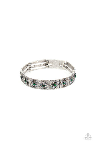Dotted with dainty green rhinestone centers, floral filigree embossed silver frames are threaded along stretchy bands around the wrist for a romantic pop of color. 