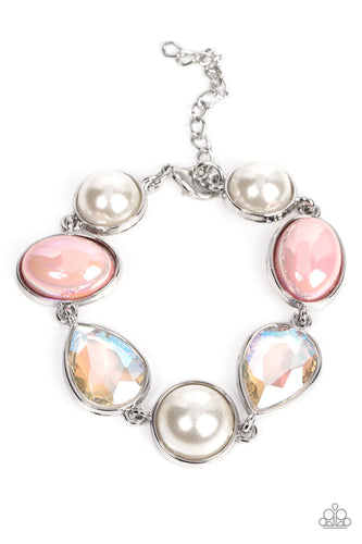 A collection of classic white pearls, iridescent Pale Rosette beads, and iridescent crystal-like teardrops wrap around the wrist in an ethereal display. Shiny silver frames encase each bead, adding a romantic vibe to the vintage inspired design. Features an adjustable clasp closure. 