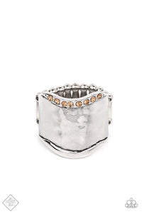 A wave of sparkling dainty light topaz rhinestones floats across the border of a wide hammered silver band. The opposite border is free of adornment, resulting in an upscale artisan edge. Features a stretchy band for a flexible fit.  Sold as one individual ring.  Fashion Fix New Kit