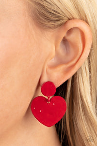 Painted in a glossy red finish, a hammered disc gives way to a hammered heart frame for a flirtatious fashion. Earring attaches to a standard post fitting.