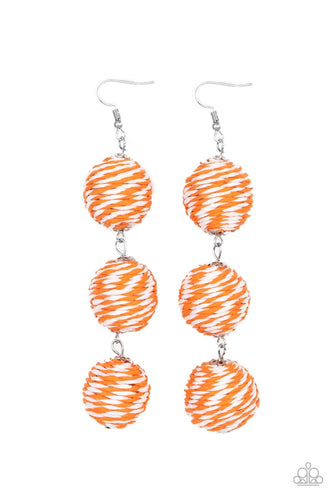 A woven collection of orange and white crepe-like strings ornately wraps around three hanging beads, reminiscent of decorative party lanterns. Earring attaches to a standard fishhook fitting. 