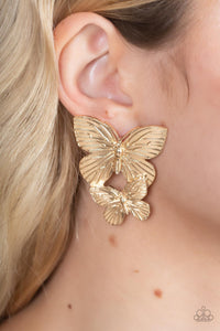 Veined with lifelike textures, a pair of golden butterflies flutters from the ear for a whimsical fashion. Earring attaches to a standard post fitting.