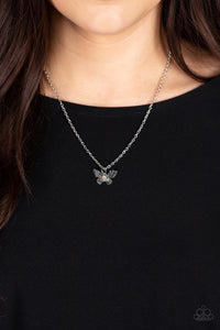 Layered with ornate silver wings, an iridescent rhinestone dotted butterfly flutters from a dainty silver chain below the collar for a whimsical fashion. Features an adjustable clasp closure. 