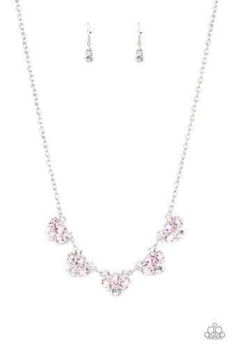 Featuring round and teardrop cuts, white and pink rhinestones delicately link into a sparkling statement piece that results into an envious glow below the collar. Features an adjustable clasp closure.