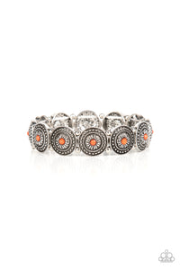 Dotted with faceted orange beaded centers, a studded collection of floral silver frames alternate with dainty silver beads along stretchy bands around the wrist for a whimsical pop of color. 