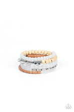 Load image into Gallery viewer, Mismatched sections of glassy and opaque white beads join silver discs, brown wooden beads, and brown disc-like beads along a coiled wire, creating an earthy infinity wrap bracelet around the wrist. 
