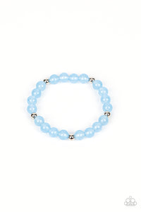 Infused with silver accents, a glassy collection of opaque blue beads are threaded along a stretchy band around the wrist for a dreamy glow.  Sold as one individual bracelet.